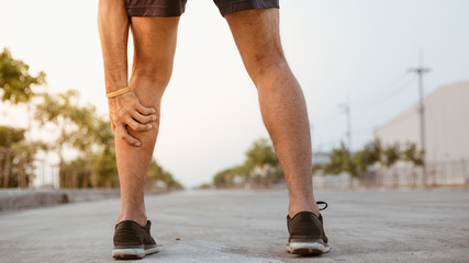 Young sport man having calf ache and problem after exercise . sport and healthy concepts