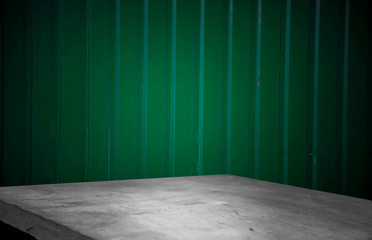 Empty wooden table on dark green blurred wall background, empty space for product above