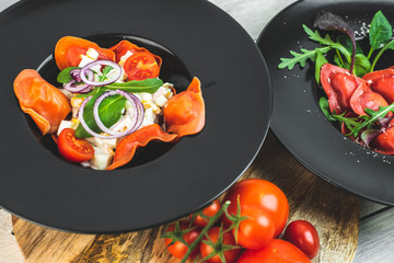 red, tomato-shaped heart-shaped ravioli, with the addition of an Italian salad