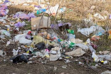 A pile of trash abandoned on the grass, littering and polluting the environment
