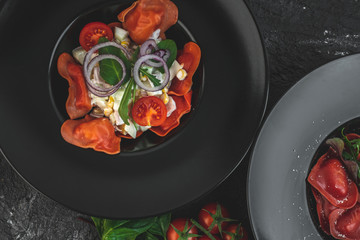 red, tomato-shaped heart-shaped ravioli, with the addition of an Italian salad