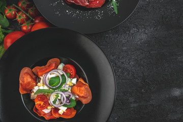 red, tomato-shaped heart-shaped ravioli, with the addition of an Italian salad