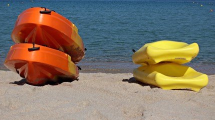 Italy, Sardinia: Canoes resting on the beach.