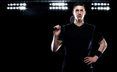 Badminton player in sportswear with racket and shuttlecock on stadium.