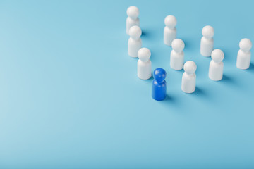 The leader in blue leads a group of white employees to victory, HR, Staff recruitment. The concept of leadership.