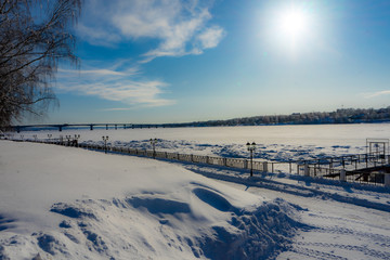 winter rural landscape with snowy trees and blue sky