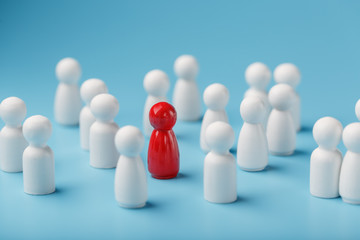 The leader in red leads a group of white employees to victory, HR, Staff recruitment. The concept of leadership.