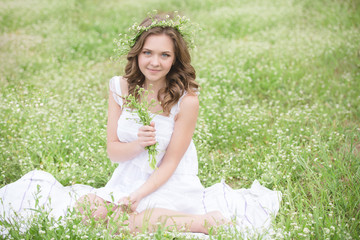 Beautiful young girl lying on the grass