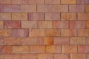 Abstract and pattern photography of a orange and yellow brick wall