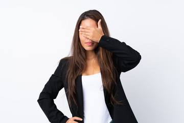 Young Brazilian girl with blazer over isolated white background covering eyes by hands