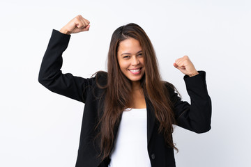 Young Brazilian girl with blazer over isolated white background celebrating a victory