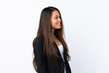 Young Brazilian girl with blazer over isolated white background looking to the side