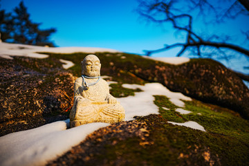 Figurines aronud a buddist temple built into a cave in seoraksan national park
