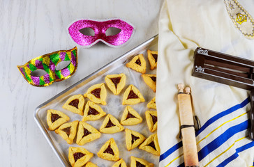 Jewish cookies for Purim with mask, tallit and noisemaker.
