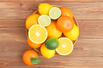 Different citrus and juicy slices on a colored background top view. Place to insert text.