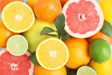 Naklejka na ściany i meble Different citrus and juicy slices on a colored background top view. Place to insert text.