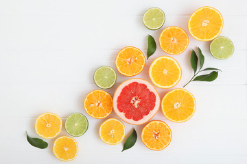 Fototapeta na wymiar Different citrus and juicy slices on a light background top view. Place to insert text.