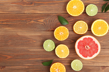 Fototapeta na wymiar Different citrus and juicy slices on a colored background top view. Place to insert text.