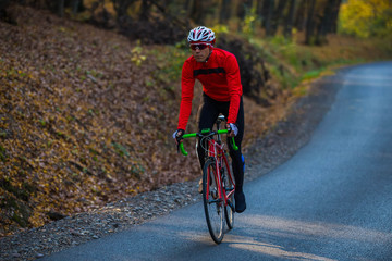 young man in bikers clothes riding a racing bicycle