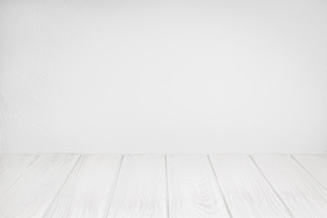 Empty Wood Table On white washed Textured wall. White background for composition. Copy space