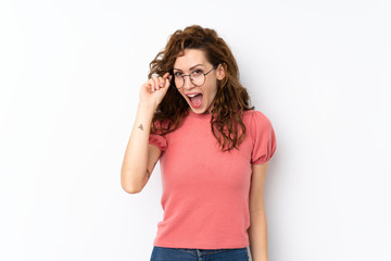 Young pretty woman over isolated background with glasses and surprised