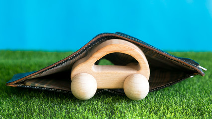 The car is safe, insured against problems. Insurance and car protection. Conceptual photo. The car is closed from problems by a purse with money