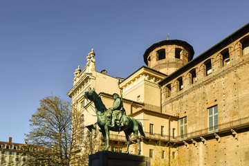 Fototapeta na wymiar Monument to the Knights of Italy (1923) by the sculptor Pietro Canonica on one side of Palazzo Madama palace and Casaforte of Acaja fortress, Turin, Piedmont, Italy