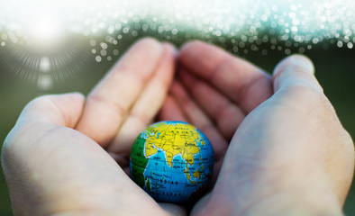 Planet Earth held in the  palms. The fragility of the planet Earth. Pray for China.