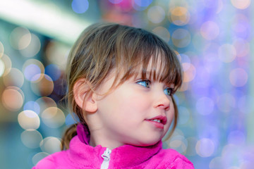 cute little girl in front of christmas decorations
