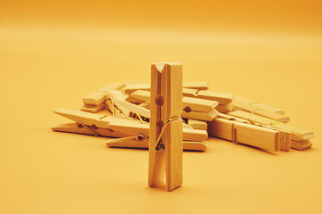 wooden pegs on yellow background