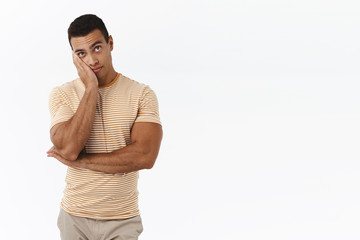 Guy looking at clock with anamused, bored face, tired sitting boring meeting on work, make facepalm, express reluctance and lack interest, standing white background dying boredom