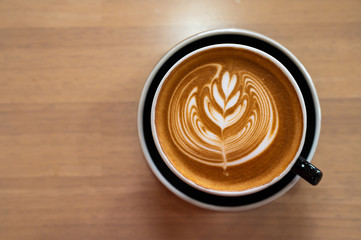Beautiful of Latte art coffee cup on wooden table, Flat lay