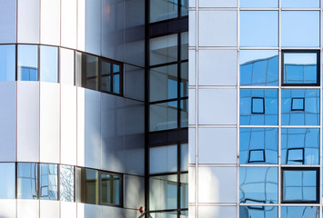 abstract patterns and reflections in windows of modern office buildings