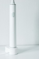 Electric toothbrush on a light background.