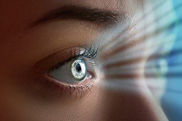 Female eye close up with smart contact lens with digital and biometric implants to scanning the...