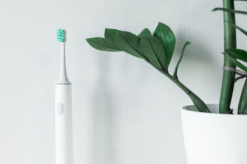 Electric toothbrush on a light background.