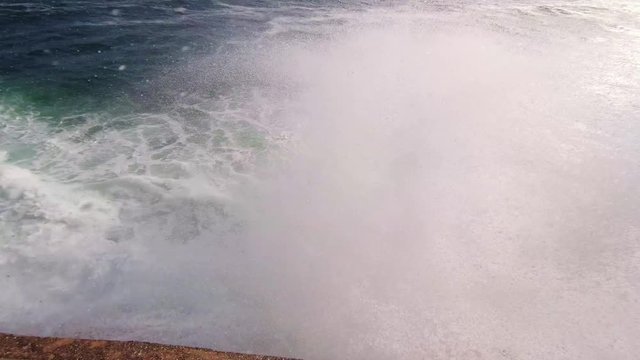 Close up of big waves crushing on the coast. Senegal, Dakar, Goree Island. Power of the Atlantic Ocean.