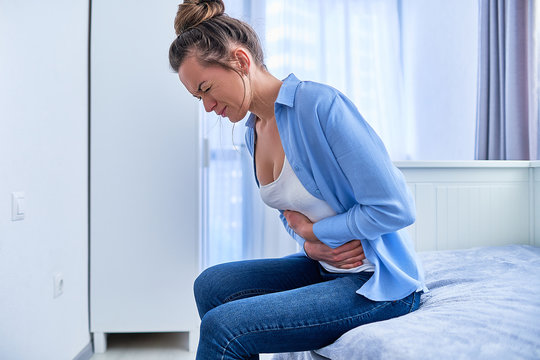 Woman Suffering From Strong Spasm Stomach Ache During Gastric Ulcer, Appendicitis Or Gastrointestinal System Disease. Health Problems