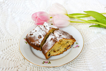 Fresh homemade cake served with tea and tulips on the crocheted table cloth