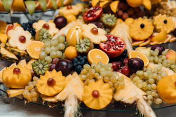 Healthy eating, assortment of raw fruits and berries. Beautiful wedding candy bar with a lot of sweets, fruits and food. Wedding banquet table