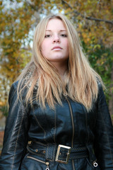 Portrait of a girl - a natural blonde with long hair in a black jacket