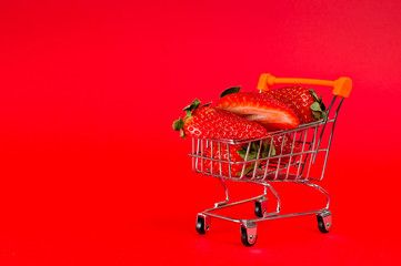 The strawberries are ripe and juicy, very tasty and healthy, close-up on a bright red background. Background for a healthy diet. Natural vitamins.