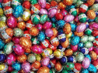 Fototapeta na wymiar Colorful Easter chocolate eggs displayed for sale in bulk 