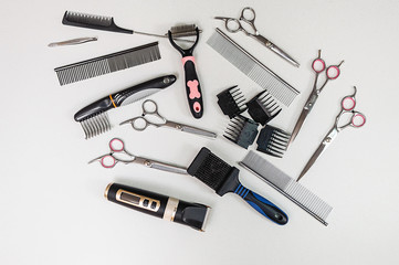 A set of tools for grooming. Shearing animals from a professional in a clinic. Scissors, trimmer, brush, comb, nozzles