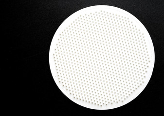 white disc with spikes on a black background