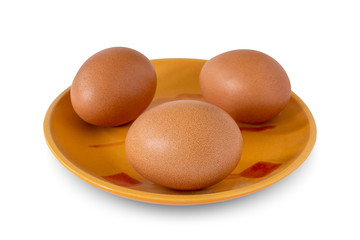 Three brown chicken eggs on a plate
