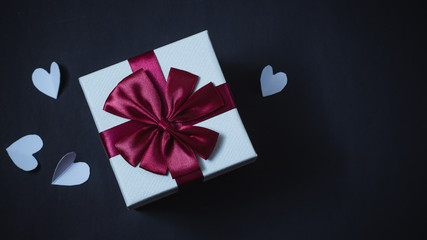 Gift boxes and hearts on a black background