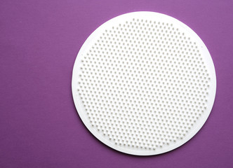 white disk with spikes on a purple background