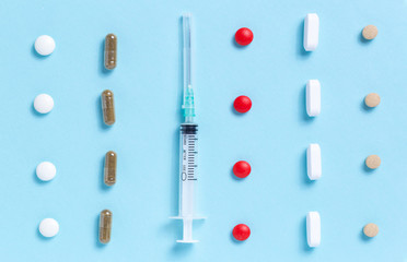 Medical syringe with rows of different colored pills