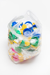 bag full of plastic caps ready to be recycled. Recycling concept. Copy space